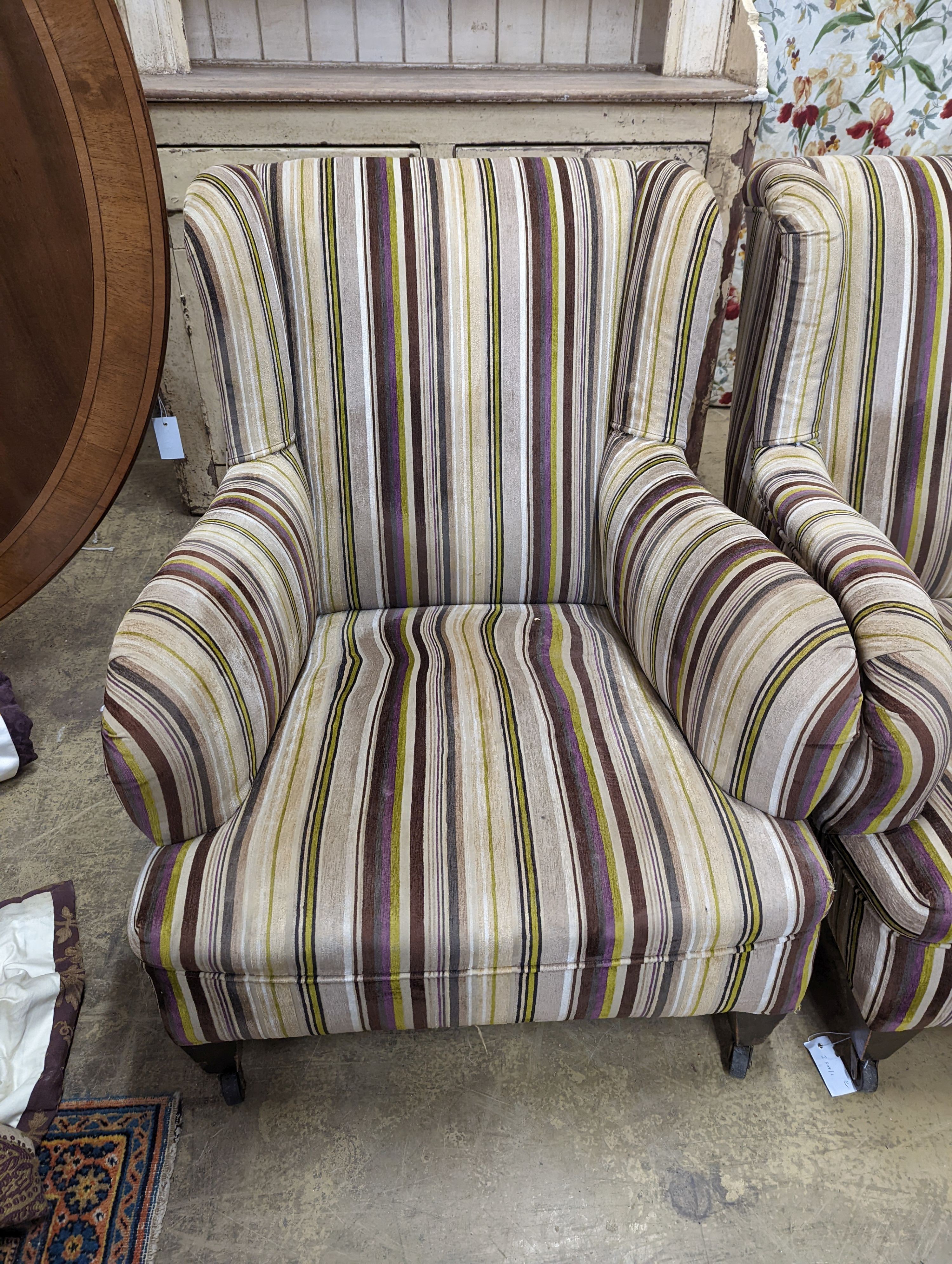 A pair of late Victorian Howard & Sons style armchairs, recently re-upholstered in a contemporary striped fabric, width 76cm, depth 88cm, height 87cm